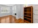 Simple bedroom with hardwood floors and a bookshelf at 700 S Prospect Ave, Clearwater, FL 33756