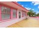 Pink house exterior with a wooden deck and seating area at 700 S Prospect Ave, Clearwater, FL 33756