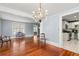 Open dining room with hardwood floors, chandelier, and kitchen view at 700 S Prospect Ave, Clearwater, FL 33756