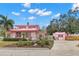 Pink house with a long driveway and guest house at 700 S Prospect Ave, Clearwater, FL 33756