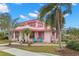Pink two-story house with palm trees and stone patio at 700 S Prospect Ave, Clearwater, FL 33756
