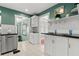 Updated kitchen, white cabinets, granite counters, and view to sunroom at 700 S Prospect Ave, Clearwater, FL 33756