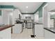 Modern white kitchen with stainless steel appliances and granite countertops at 700 S Prospect Ave, Clearwater, FL 33756