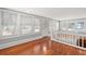 Upper level landing with hardwood floors and railing at 700 S Prospect Ave, Clearwater, FL 33756