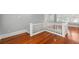 White railing staircase leading to upper level with hardwood floors at 700 S Prospect Ave, Clearwater, FL 33756