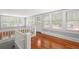 Upper level loft with hardwood floors, multiple windows, and white railing at 700 S Prospect Ave, Clearwater, FL 33756