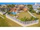 Backyard oasis with pool, patio, lush landscaping, and a white fence at 710 Islebay Dr, Apollo Beach, FL 33572