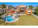 Aerial view showcasing home, pool, and lush landscaping at 710 Islebay Dr, Apollo Beach, FL 33572