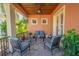 Covered patio with seating area, wood ceiling, and lush greenery at 710 Islebay Dr, Apollo Beach, FL 33572