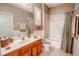Bathroom with wooden vanity, tub shower, and toilet at 710 Islebay Dr, Apollo Beach, FL 33572