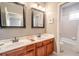 Double vanity bathroom with two sinks and a mirror at 710 Islebay Dr, Apollo Beach, FL 33572