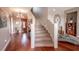 Grand entryway with curved staircase and hardwood floors at 710 Islebay Dr, Apollo Beach, FL 33572
