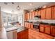Modern kitchen with wood cabinets and granite countertops at 710 Islebay Dr, Apollo Beach, FL 33572