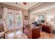 Home office with built-in desk, hardwood floors and French doors at 710 Islebay Dr, Apollo Beach, FL 33572
