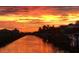 Scenic sunset over a canal with boats and waterfront homes at 710 Islebay Dr, Apollo Beach, FL 33572