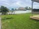 Large grassy backyard with a covered patio and tiki hut at 8540 Riverside, St Petersburg, FL 33702