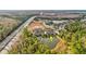 Wide aerial view showcasing the community and its pond at 11902 Greengate Dr, Hudson, FL 34669