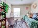 Cozy bedroom with a plush green bed, a comfy armchair, and built-in shelving at 11902 Greengate Dr, Hudson, FL 34669