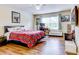 Bedroom with plaid bedding, hardwood floors, and workspace at 11902 Greengate Dr, Hudson, FL 34669