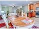 Dining area with an oval table and chairs, kitchen view at 11902 Greengate Dr, Hudson, FL 34669