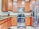 Updated kitchen with stainless steel appliances and wood cabinets at 11902 Greengate Dr, Hudson, FL 34669