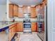 Modern kitchen featuring stainless steel appliances and wood cabinetry at 11902 Greengate Dr, Hudson, FL 34669