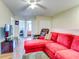 Spacious living area with red sectional sofa and hardwood floors at 11902 Greengate Dr, Hudson, FL 34669