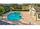 Community pool with lounge chairs and a pool house at 11902 Greengate Dr, Hudson, FL 34669