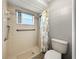 Small bathroom with shower stall, toilet, and grab bars at 10454 Ventura Dr, Spring Hill, FL 34608
