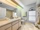 Bathroom with large vanity, toilet and shower bathtub combo at 10454 Ventura Dr, Spring Hill, FL 34608