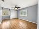 Bedroom with wood flooring, window with shutters and ceiling fan at 10454 Ventura Dr, Spring Hill, FL 34608