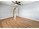 Light grey bedroom with laminate floors and ceiling fan at 10454 Ventura Dr, Spring Hill, FL 34608