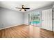 Bedroom with pool view, laminate wood floor, and sliding glass door at 10454 Ventura Dr, Spring Hill, FL 34608