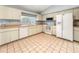 Eat-in kitchen featuring white appliances and tiled floors at 10454 Ventura Dr, Spring Hill, FL 34608