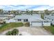 Single story home with a two car garage and landscaped yard at 11185 5Th E St, Treasure Island, FL 33706
