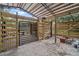 Covered area with wooden stalls and gate, perfect for small animals at 11518 Hammock Oaks Ct, Lithia, FL 33547