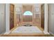 Spa-like bathroom with soaking tub and shower, designed with tile and columns at 11518 Hammock Oaks Ct, Lithia, FL 33547
