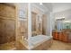 Elegant bathroom with soaking tub, walk-in shower, and granite finishes at 11518 Hammock Oaks Ct, Lithia, FL 33547