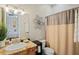 Guest bathroom with granite vanity and shower/tub combo at 11518 Hammock Oaks Ct, Lithia, FL 33547
