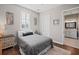 Bright bedroom with a double bed, hardwood floors, and access to a full bathroom at 11518 Hammock Oaks Ct, Lithia, FL 33547
