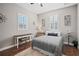 Cozy bedroom with a comfortable bed, wood floors, and plenty of natural light at 11518 Hammock Oaks Ct, Lithia, FL 33547