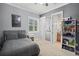 Bedroom with gray bedding, built-in shelves, and access to bathroom at 11518 Hammock Oaks Ct, Lithia, FL 33547