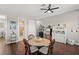 Dining area with round table, wicker chairs, and view into kitchen at 11518 Hammock Oaks Ct, Lithia, FL 33547