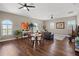 Open dining area with round table, wicker chairs, and hardwood floors at 11518 Hammock Oaks Ct, Lithia, FL 33547