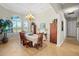Bright dining room features a large table and hardwood floors at 11518 Hammock Oaks Ct, Lithia, FL 33547