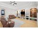 Gathering room with built-in shelving and a large TV at 11518 Hammock Oaks Ct, Lithia, FL 33547