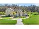 Two-story house with circular driveway and lush landscaping at 11518 Hammock Oaks Ct, Lithia, FL 33547