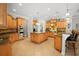 Large kitchen with island, granite countertops, and wood cabinets at 11518 Hammock Oaks Ct, Lithia, FL 33547