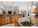 Spacious kitchen boasts granite countertops, stainless steel appliances, and large island at 11518 Hammock Oaks Ct, Lithia, FL 33547