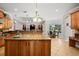 Gourmet kitchen with island, granite countertops, and custom cabinetry at 11518 Hammock Oaks Ct, Lithia, FL 33547
